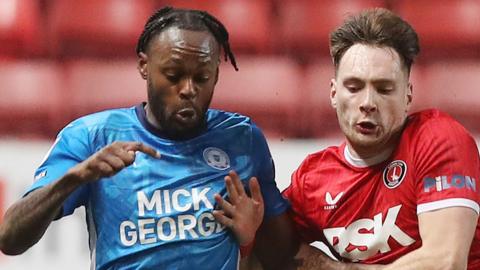 Ricky-Jade Jones of Peterborough United battles with Josh Edwards of Charlton Athletic 