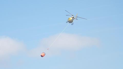 Helicopter deploying water