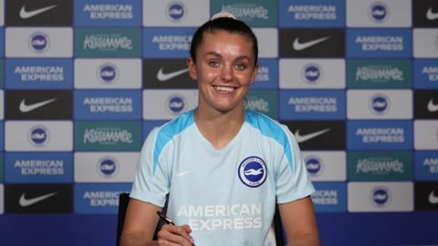 Caitlin Hayes poses after signing for Brighton