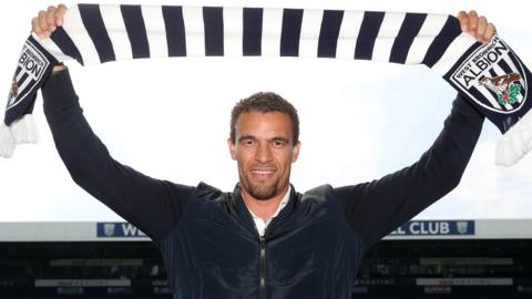 Valerien Ismael holds up a West Bromwich Albion scarf