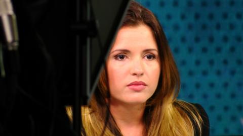 A presenter sits on the set of Canal Caribe's El Mundo ahora