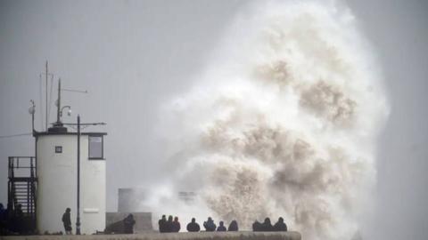 Waves crash over the seafront in Porthcawl in Wales