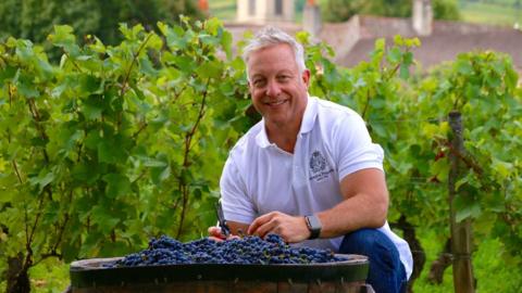 Michael Baum with a barrel of grapes