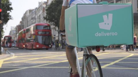 Rear of Deliveroo rider on pedal bike