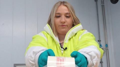 Natasha Varley, food inspector tapes boxes of chicken up