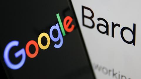 Google and Bard logos seen on phone and laptop