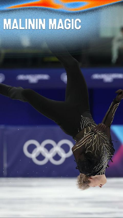 Ilia Malinin performs a somersault on the ice rink during his routine