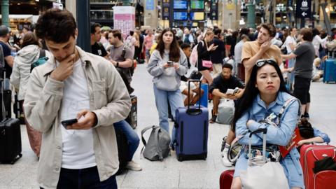 Stranded passengers wait inside Gare du Nord station in Paris