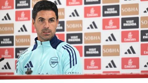 Mikel Arteta sits and talks at a news conference