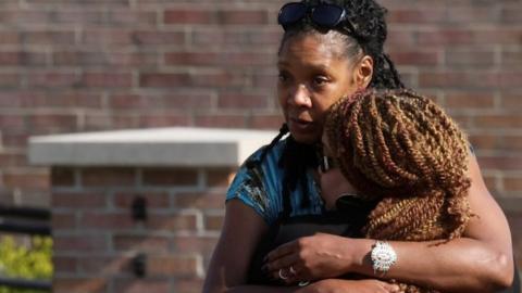 Mourners embrace at a vigil in Buffalo