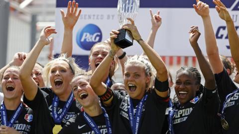 Rachel Daly lifts the trophy after winning the NWSL Challenge Cup Final with Houston Dash