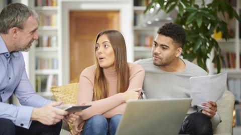 Couple talking with financial advisor