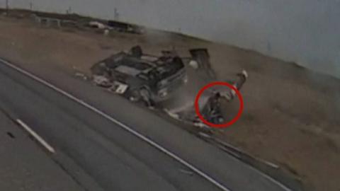 Man appears from wreckage of a flipped RV on side of highway