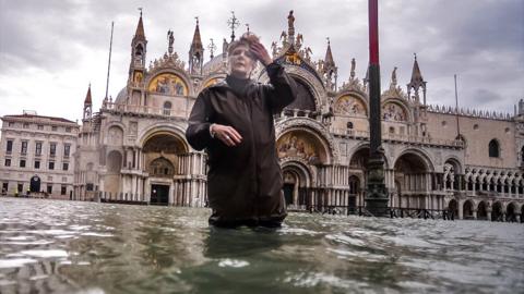 Woman in flooded Venice