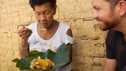 Chef watches as woman eats