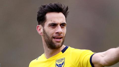 Sam Baldock signals to his team-mates during a match