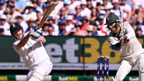 Harry Brook hits into the leg side as wicketkeeper Alex Carey watches on