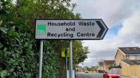 A sign which reads Household Waste and Recycling Centre. 