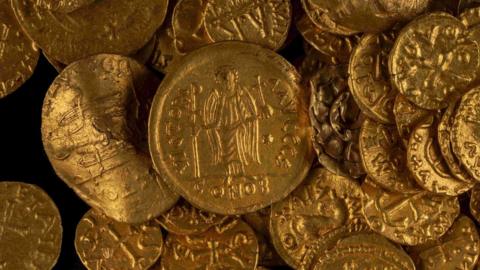 A close-up of the West Norfolk hoard which includes detail of a Byzantine gold solidus. The hoard is a group of gold coins.