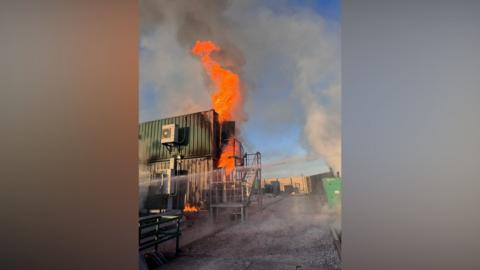 Flames are seen on the outside of a building