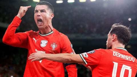 Cristiano Ronaldo of Portugal celebrates alongside Bernardo Silva