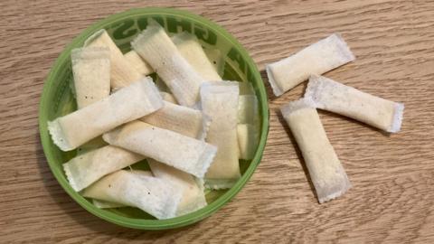 Nicotine pouches in a green bowl on a table