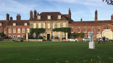 Mompesson House as seen from Salisbury Cathedral Green as the sun sets.