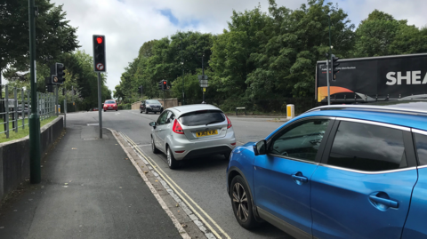 Cars waiting at the Maumbury crossroads 