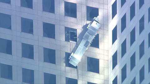 Scaffolding dangling on the side of building