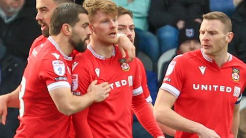 Andy Cannon (centre) is congratulated by Elliot Lee after scoring for Wrexham