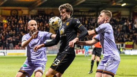 Livingston's Robbie Muirhead (centre) is challenged