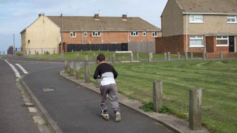 Boy plays on the street in Hartlepool