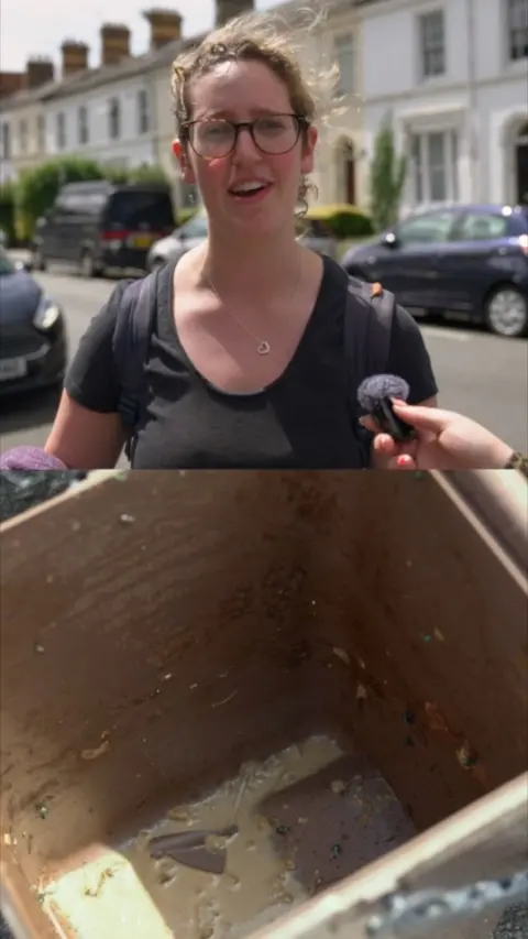Split screen, In top is woman with black t shirt standing on residential street. Bottom is inside of a wood box.