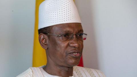 Mali's Prime Minister Choguel Maïga, wearing glasses, a white robe and cap