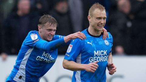 Peterborough players celebrate a goal against Charlton