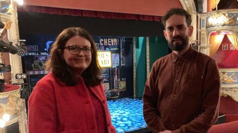 Novae Baghurst on the left and Graham McKnight on the right standing on the balcony in Crewe's Lyceum Theatre