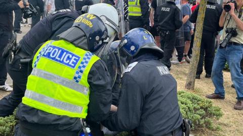 Police tackle a rioter in Rotherham summer 2024