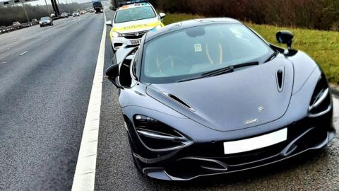 Black McLaren pulled over by police on the A1(M) near Peterborough.