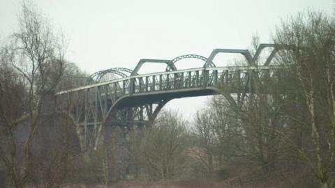 A view of the Warburton toll bridge, which is a steel structure spanning the Manchester Ship Canal. 
