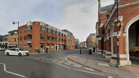 A general view picture from Google Maps of the office building on the left - a three-storey building - opposite the brick Windsor and Eton Riverside train station.