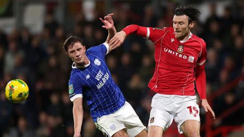 Cardiff City defender Will Fish (L) battles with Wrexham striker Kieffer Moore (R)