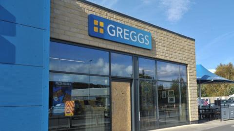 The Greggs store with a boarded-up door