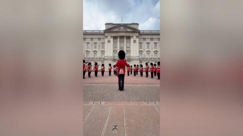Buckingham Palace guards play their instruments.