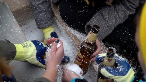 A woman making Molotov cocktails