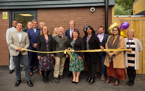 Dignitaries cut the ribbon outside flagship homeless accommodation 