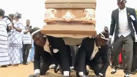 Pallbearers carrying a coffin on the backs