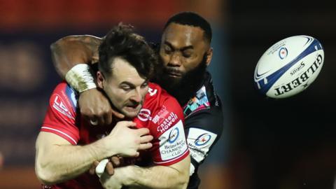 Ryan Conbeer of Scarlets is tackled by Semi Radradra