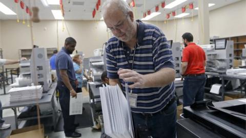 A device is used to straighten ballots before machine counting during a recount at the Broward County Supervisor of Elections office on November 11, 2018 in Lauderhill, Florida. A statewide vote recount is being conducted to determine the races for governor, Senate, and agriculture commissioner.