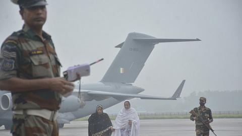 Passengers disembark from Indian Air Force's C-17 Globemaster at Hindon Air Force Station after being evacuated from Kabul