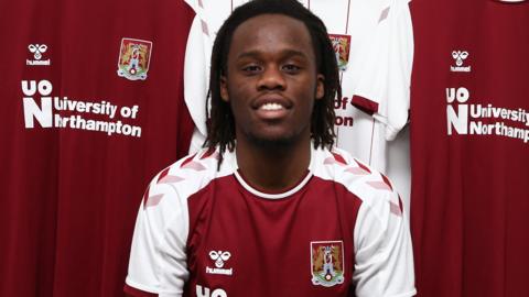 Peter Kioso poses in a Northampton shirt